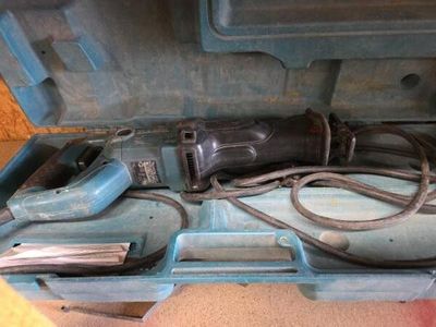 une boîte à outils bleue avec des outils sur le sol