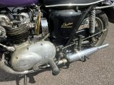 a close up of a motorcycle parked in a parking lot