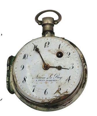 a close up of a pocket watch on a white background