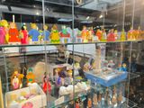 a glass display case filled with various toys and figurines