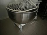 a large metal bowl with a mesh top on a stand