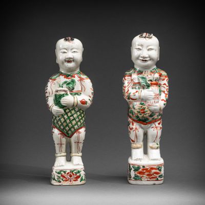 pair of chinese porcelain figurines of a boy and a girl