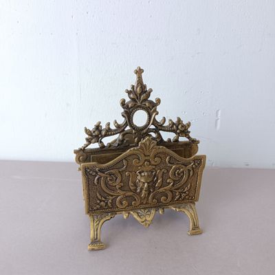 brass plate with ornate design on top of it on a table
