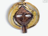 an image of a brown and yellow mask on a white background