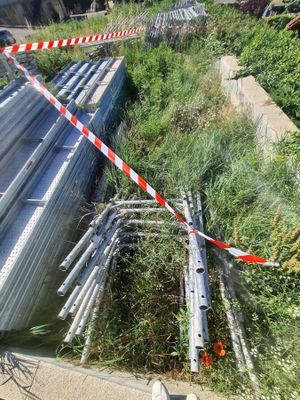 a pile of metal pipes on the side of the road