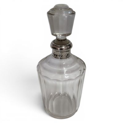 an image of a clear glass bottle with a metal stopper