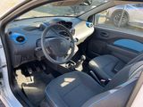 the interior of a small car with a steering wheel and a dashboard