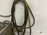 a large hose attached to a wall next to a metal basket