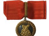 une image représentant une médaille entourée d'un ruban rouge