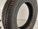 a close up of a tire on a white surface with a wren next to it