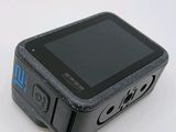 a small black cell phone sitting on top of a white table