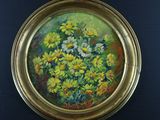 painting of yellow and white flowers in a gold frame on a black surface