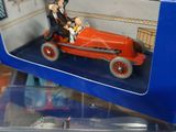 a toy car with a man and a woman in a car