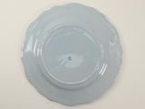 a blue plate on a white table with a white background