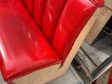 a red bench that is sitting in the back of a truck