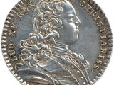 a close up of a coin on a white surface