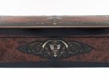 a small wooden box with a decorative design on it