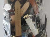 a bag full of watches and other watches on a table