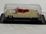 a yellow car in a glass case on a white surface