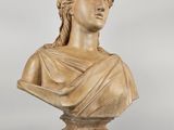 a carved bust of a woman wearing a headdress