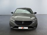 the front view of a grey car parked in a showroom