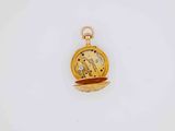 a small gold pocket watch with a chain on it