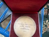 a medal in a box sitting on a blue chair
