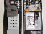two pieces of plastic that have been removed from the back of a cell phone