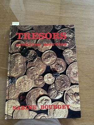 a book that is sitting on a table with coins on it