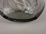 a glass vase with a flower inside of it