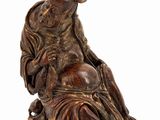 an image of a statue of a person sitting on a chair