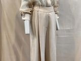 an image of a mannequin wearing a white shirt and pants