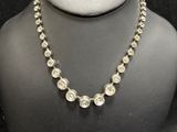 the necklace is made of glass beads and silver beads