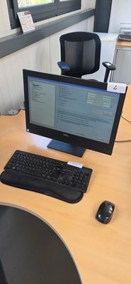 a desk with a computer, keyboard and mouse on it