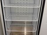 an empty refrigerator that is sitting in the corner of a room