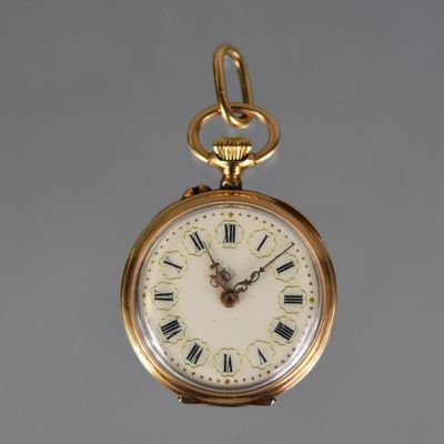 a gold pocket watch with roman numerals on the face