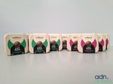 four boxes of coffee are lined up on a table