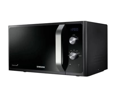 the samsung microwave oven is black and has a digital clock on it