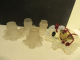 three glass vases and a bell on a table