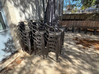 de nombreuses chaises et un parasol sur la terrasse