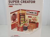 boxed box of a doll house with a table and chairs in it