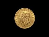 a close up of a gold coin on a black background