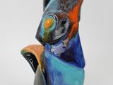 a colorful bird that is sitting on top of a table