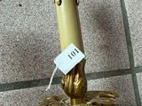 a candle that is sitting on the floor with a price tag on it