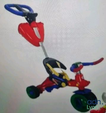 a picture of a toy tricycle being pulled by a person