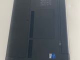 the laptop is sitting on a table with a blue sticker on the back of it