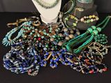 a lot of beads and jewelry on a table