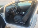 a picture of a white car with black seats and a steering wheel