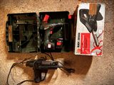 a box with a drill and a cord in it on the floor