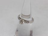 an image of a diamond ring on top of a clear glass